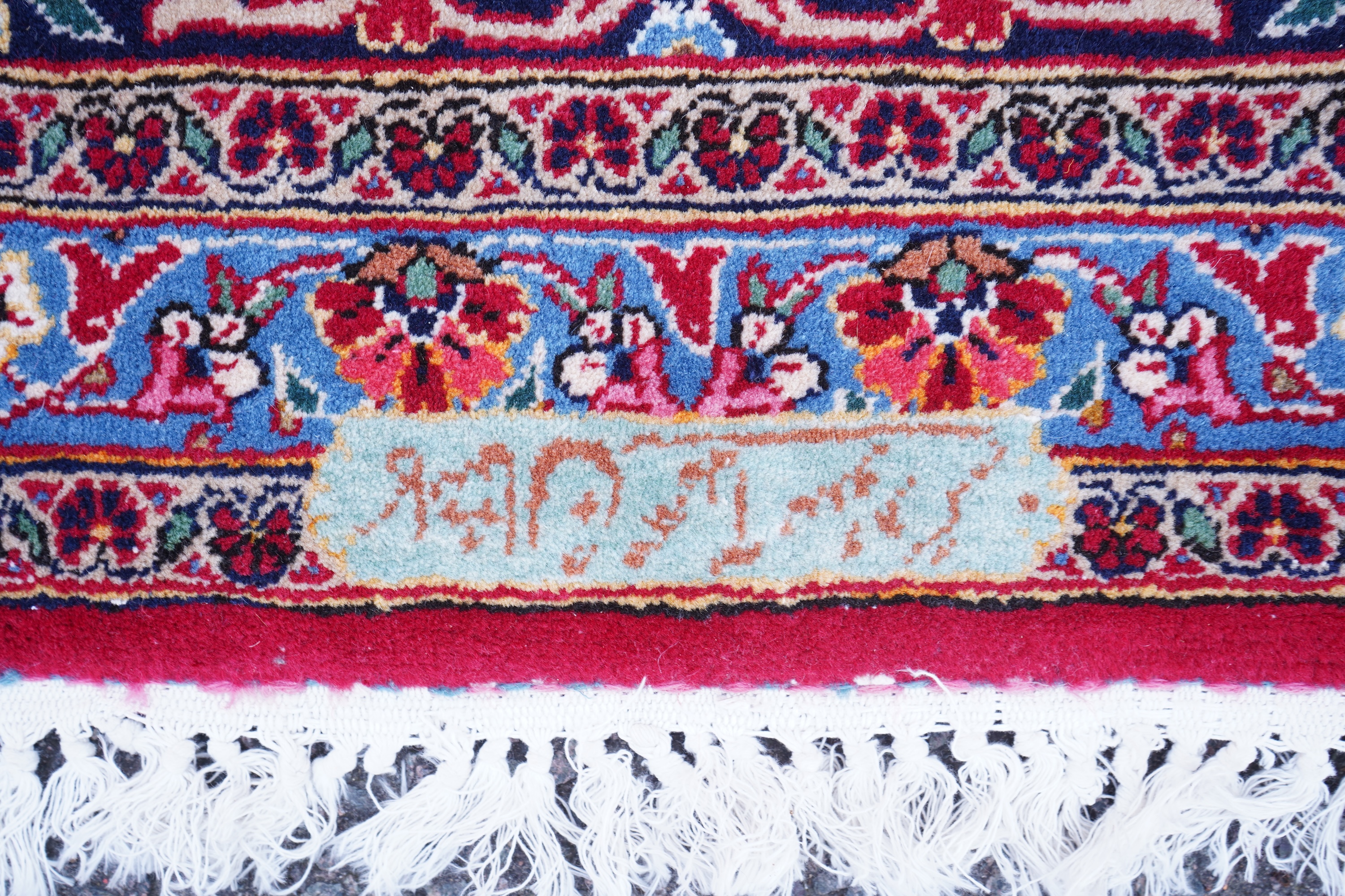 A Kashan burgundy ground carpet